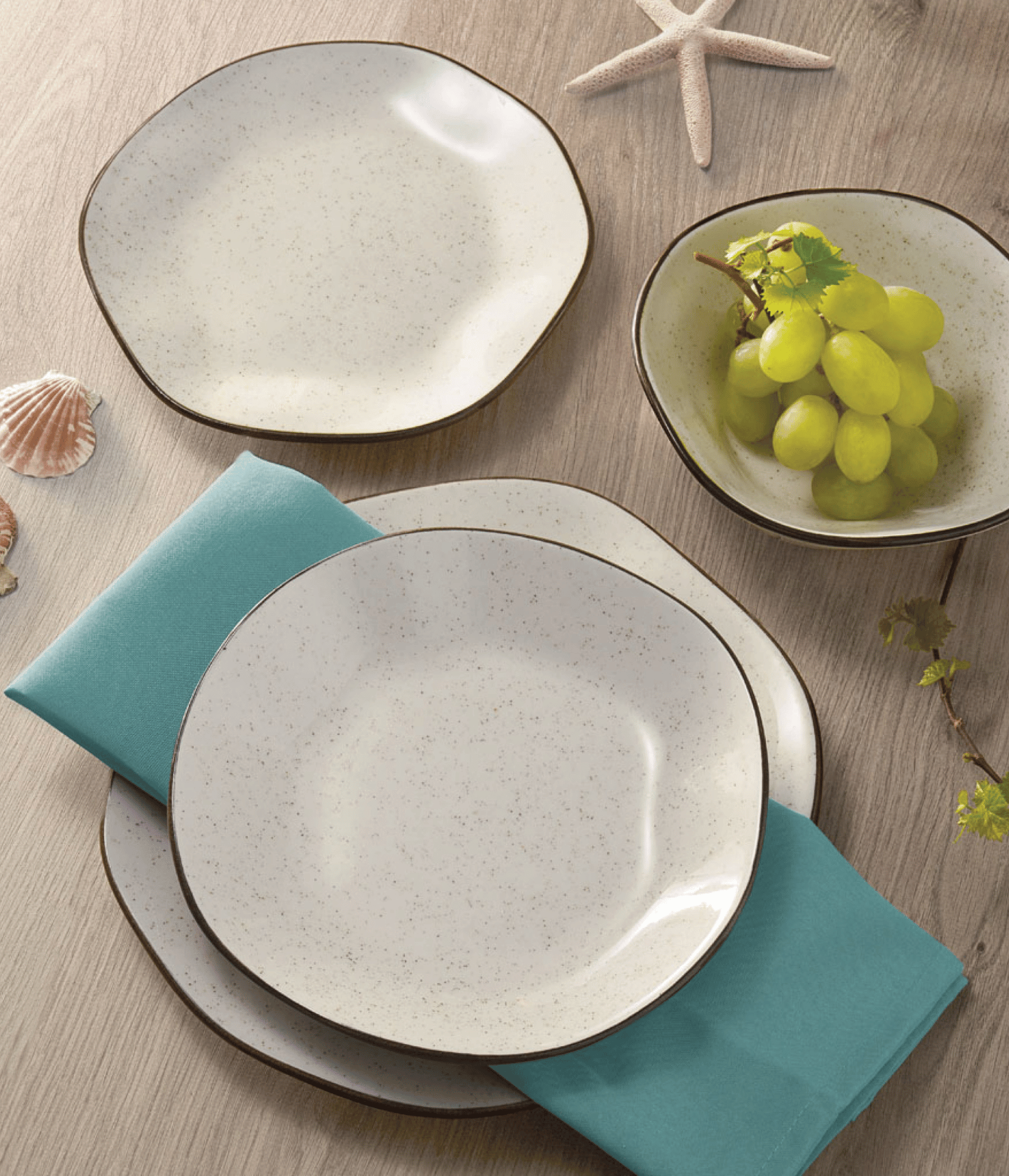 Starfish and seashells next to tableware