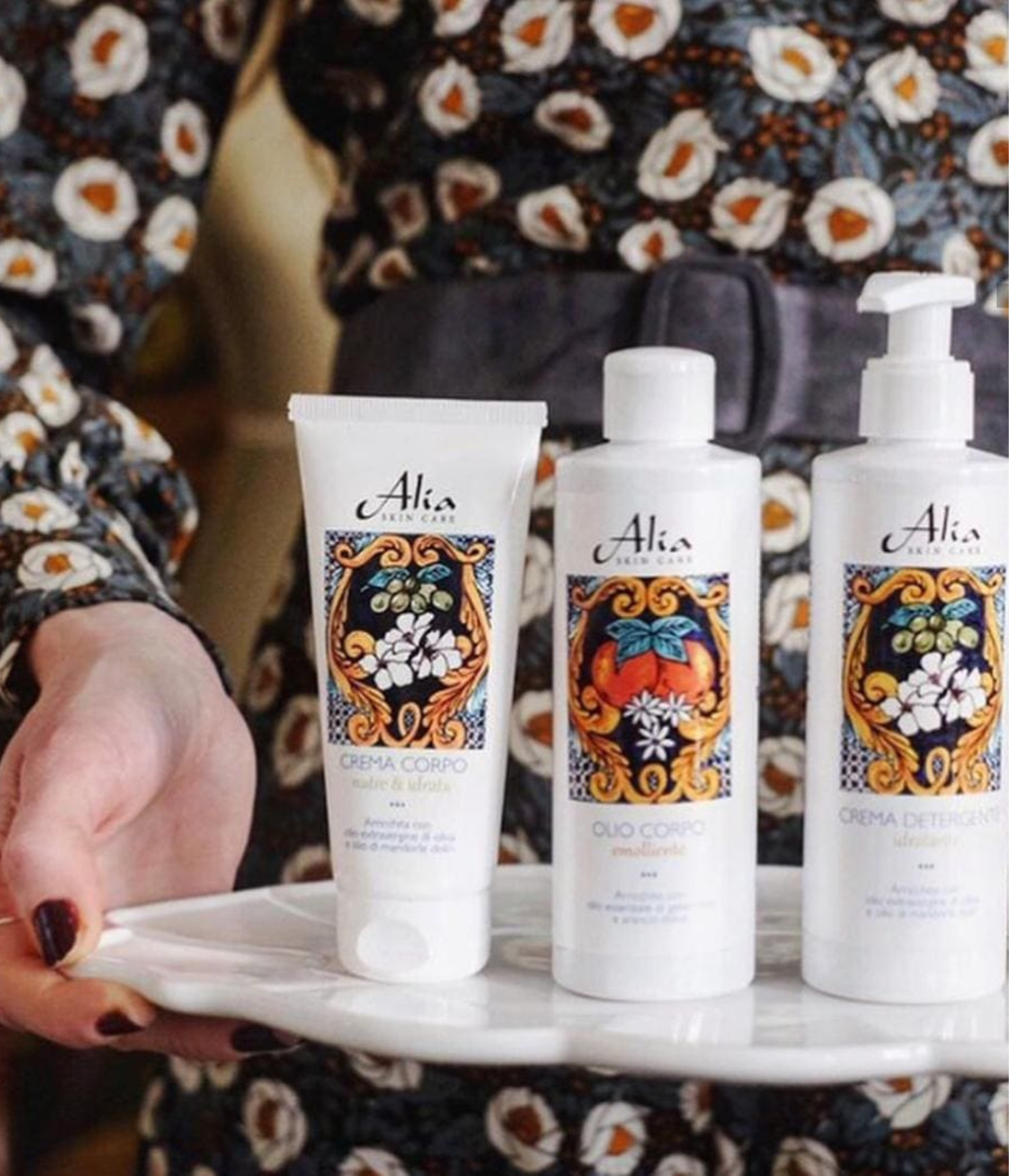 A woman holds a tray of skincare