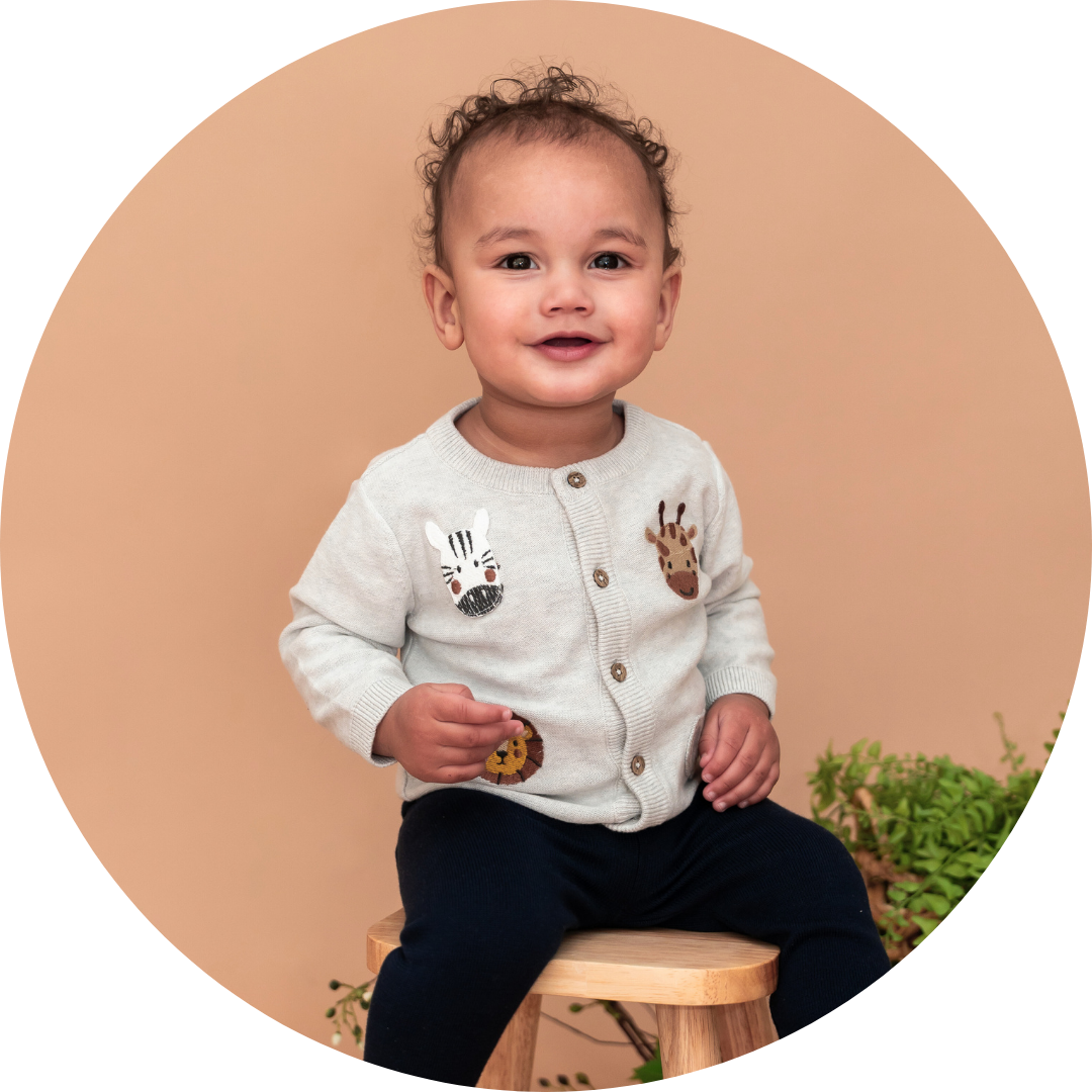 Baby sits on a stool