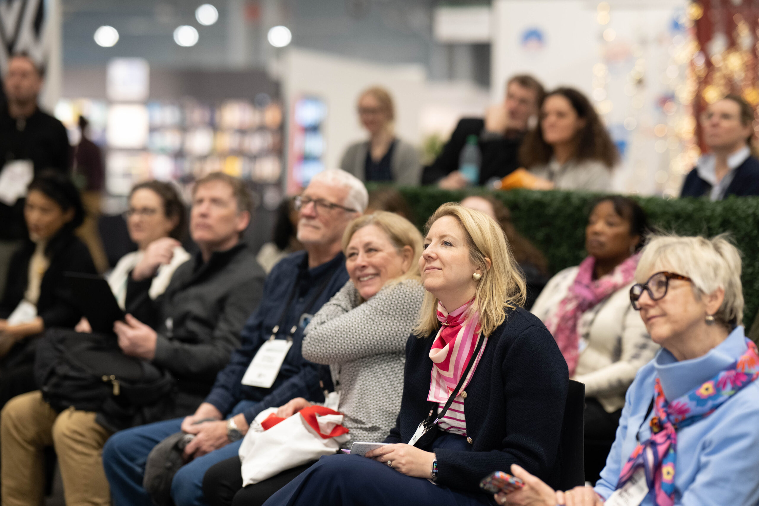 Audience members lean into a talk at a tradeshow