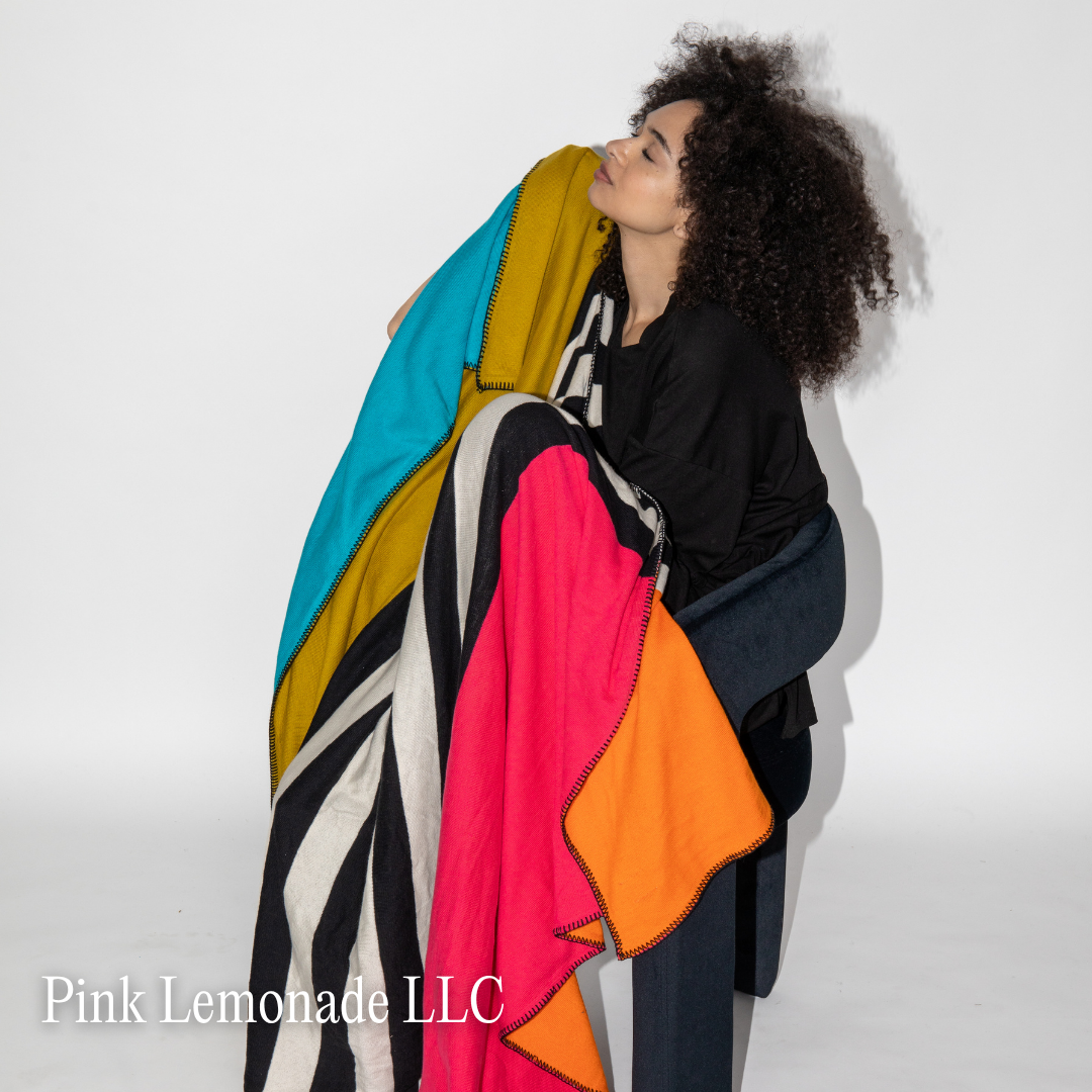 Pink Lemonade LLC A lady wrapped in a colorful blanket