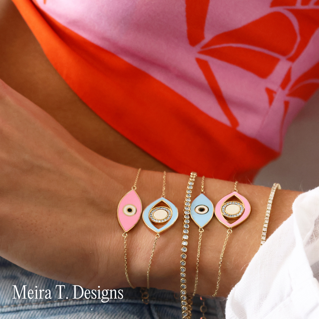 Meira T. Designs A stack of evil eye bracelets